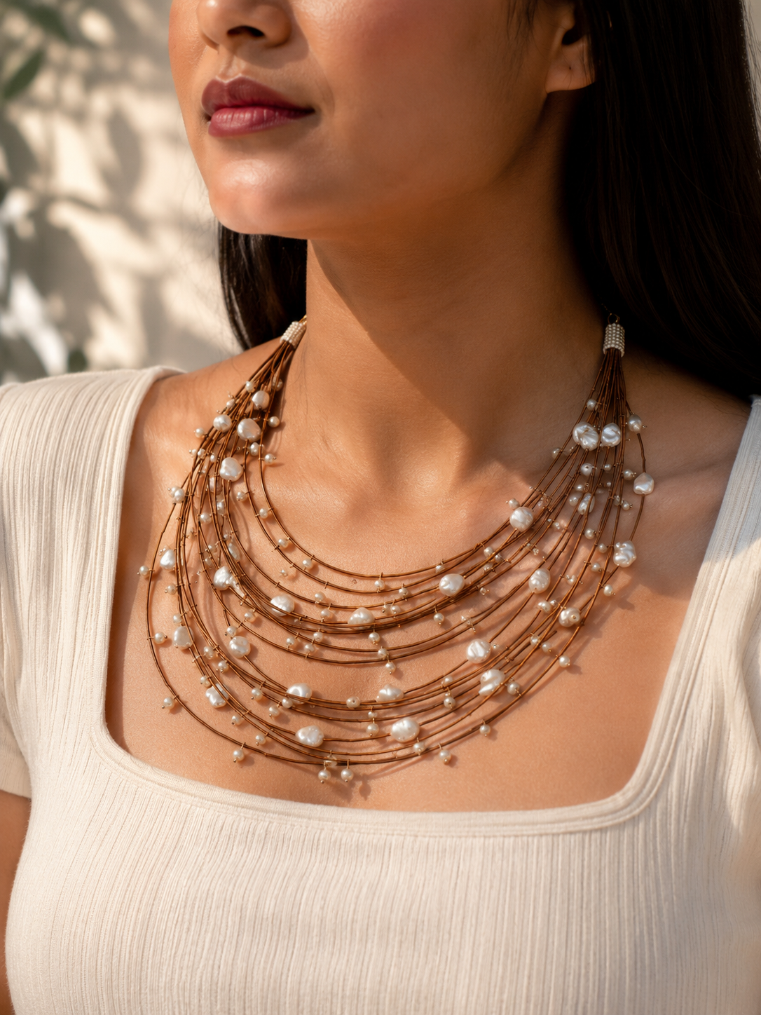 Pearl Wire-Layered Necklace – model wearing multi-strand pearl wire layered necklace