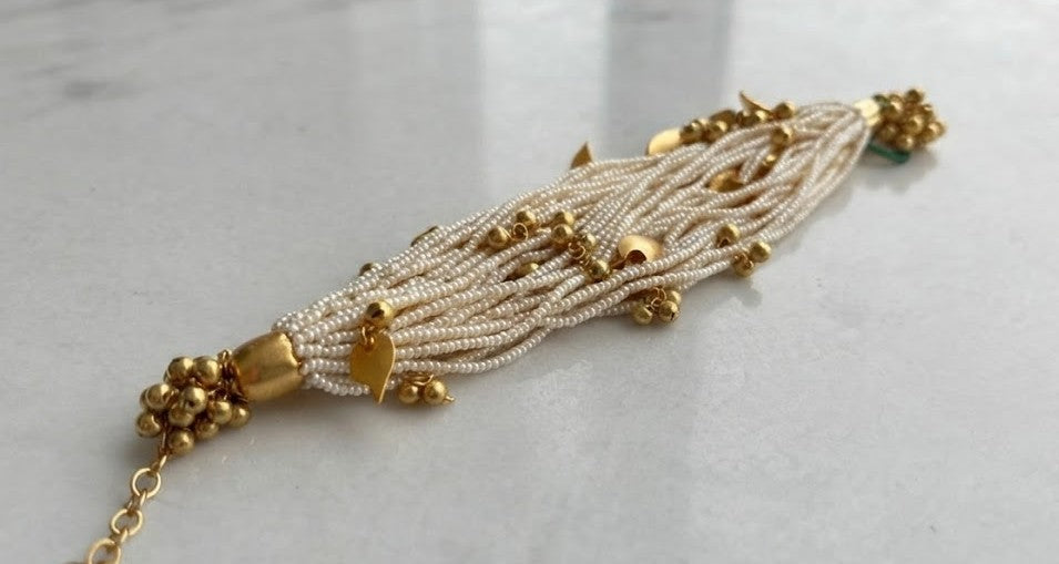 Maya Pearl Tassel Bracelet - gold-tone cuff with pearl clusters and tassel drops