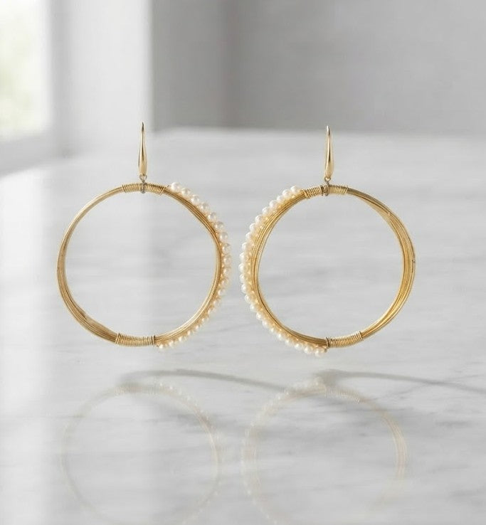 Pearl Arc Hoops — golden wire hoops wrapped in lustrous natural seed pearls from the Metrolife collection by Mine of Design
