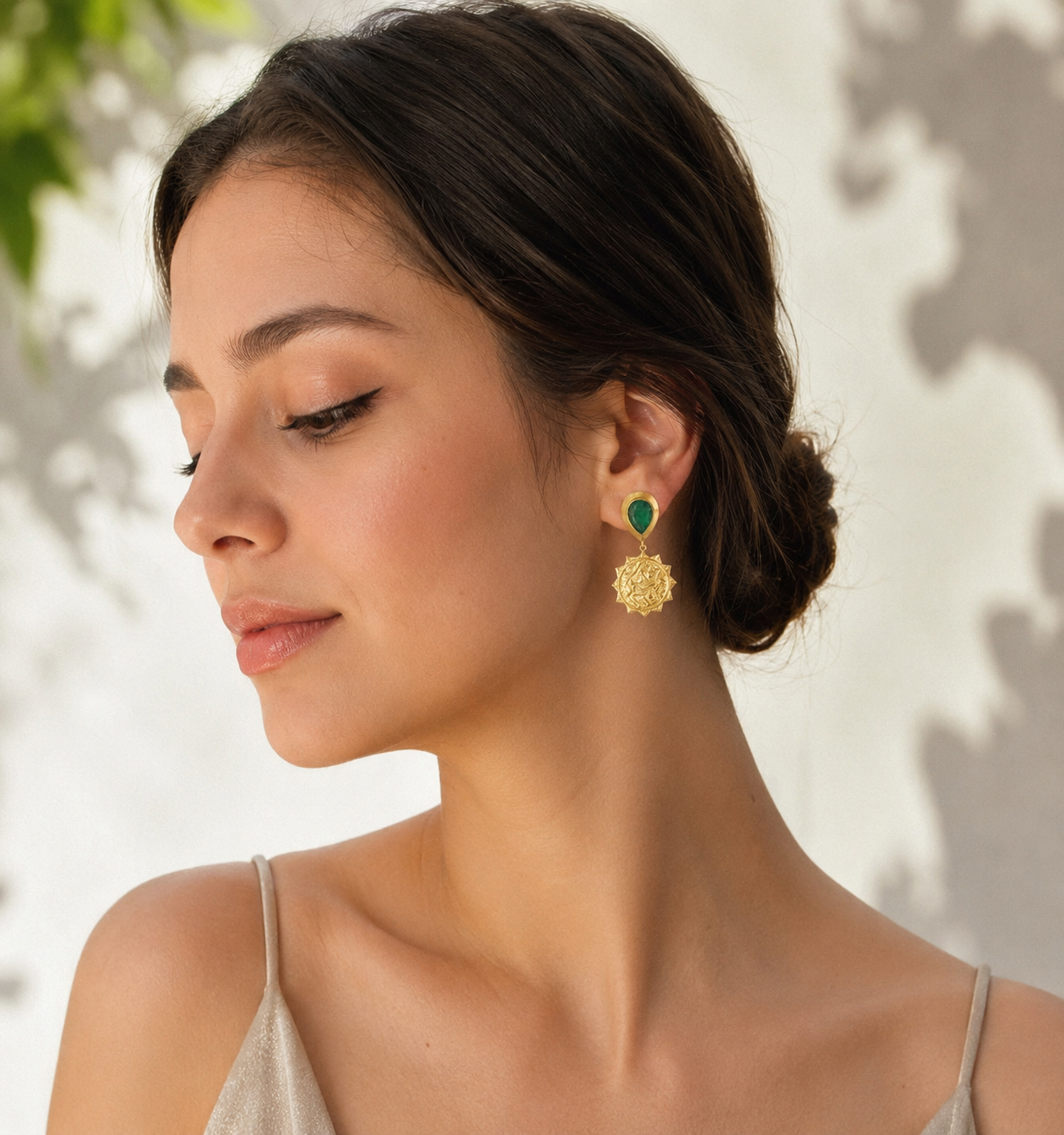 The Radiant Emerald Sunbursts Earrings – model wearing emerald and sunburst coin dangles